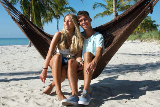 siblings enjoying hammock time together at the beach