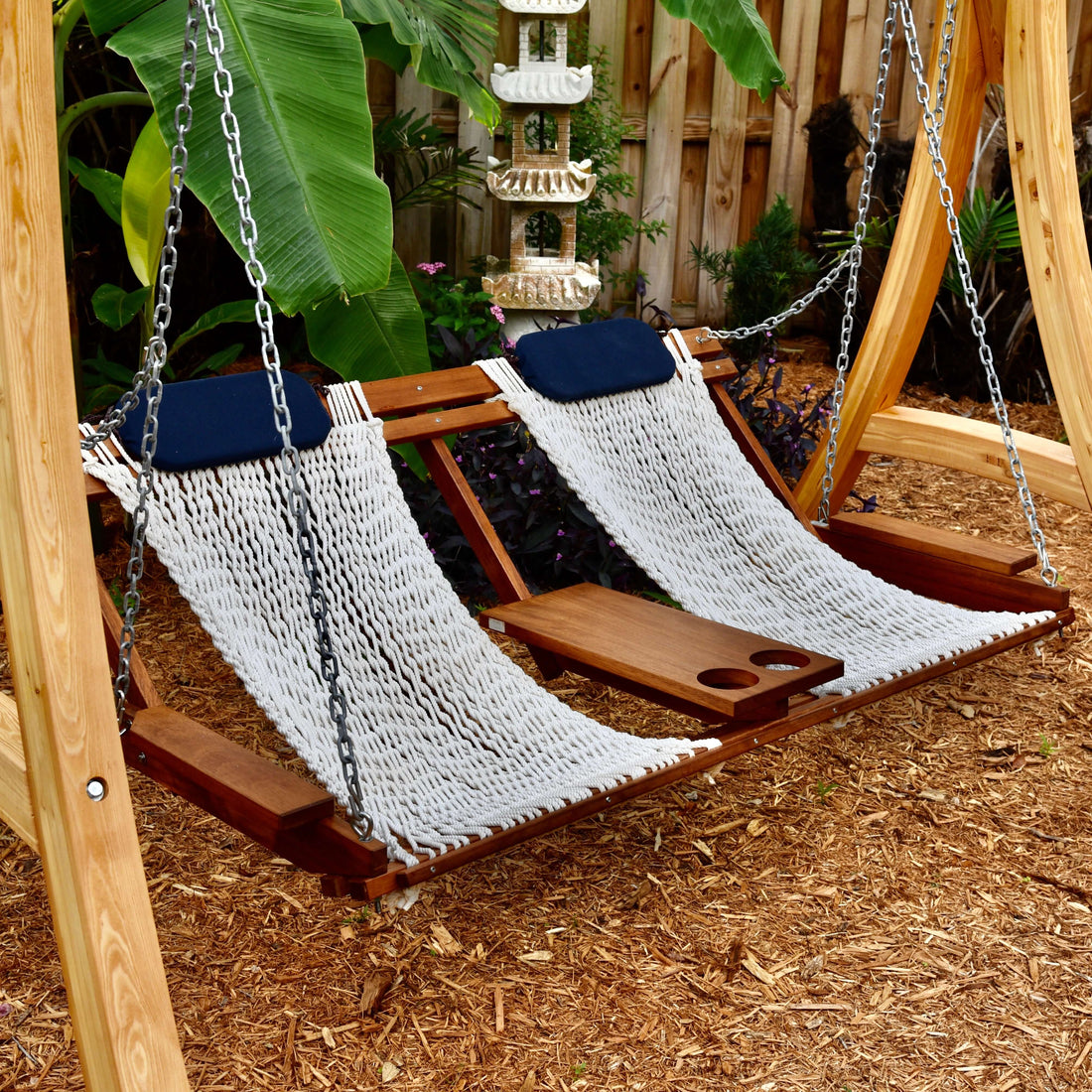 double porch swing with center table and cup holders in a key west garden