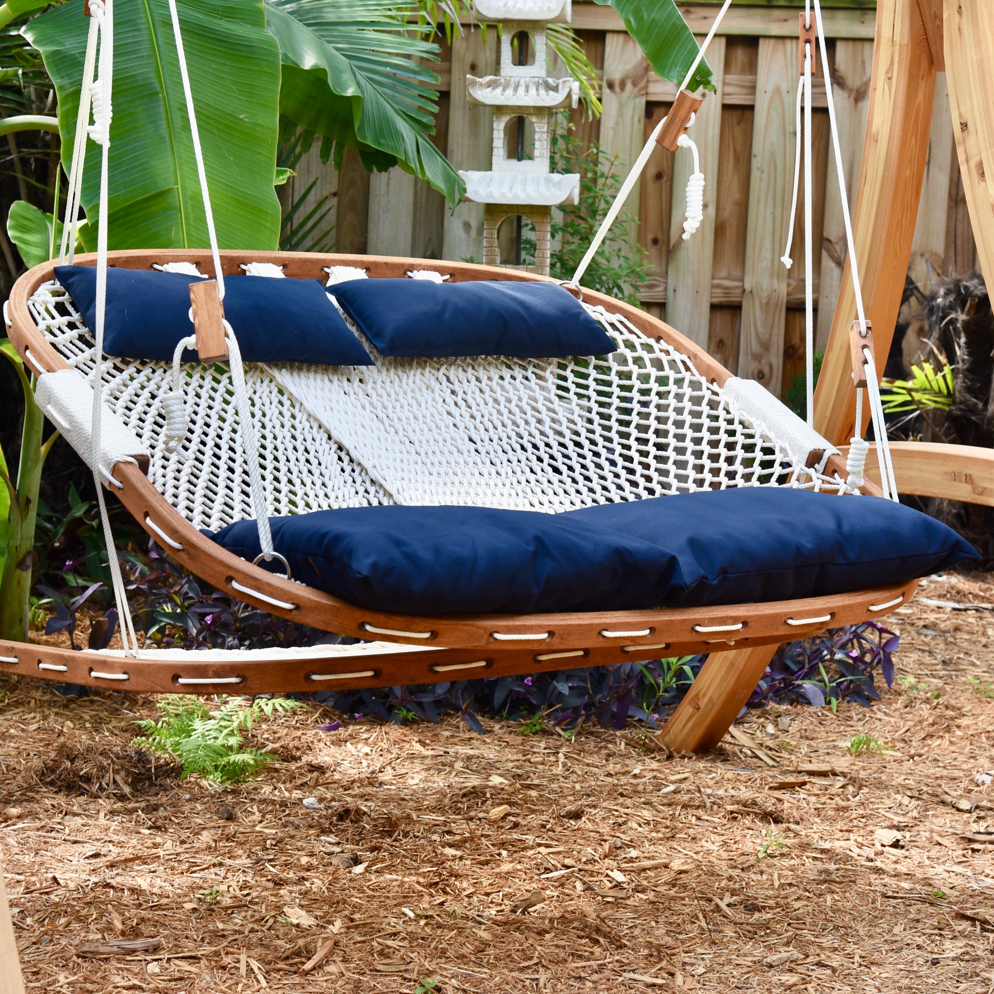 comfortable looking porch swing in a wood stand