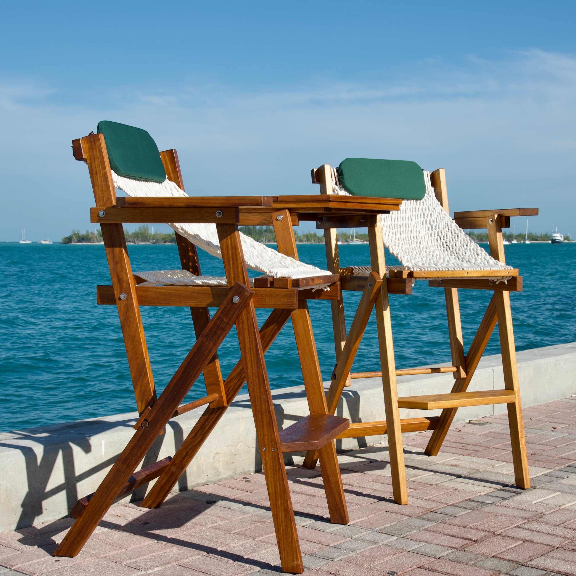 bautiful barstools with ocean and an island behind it