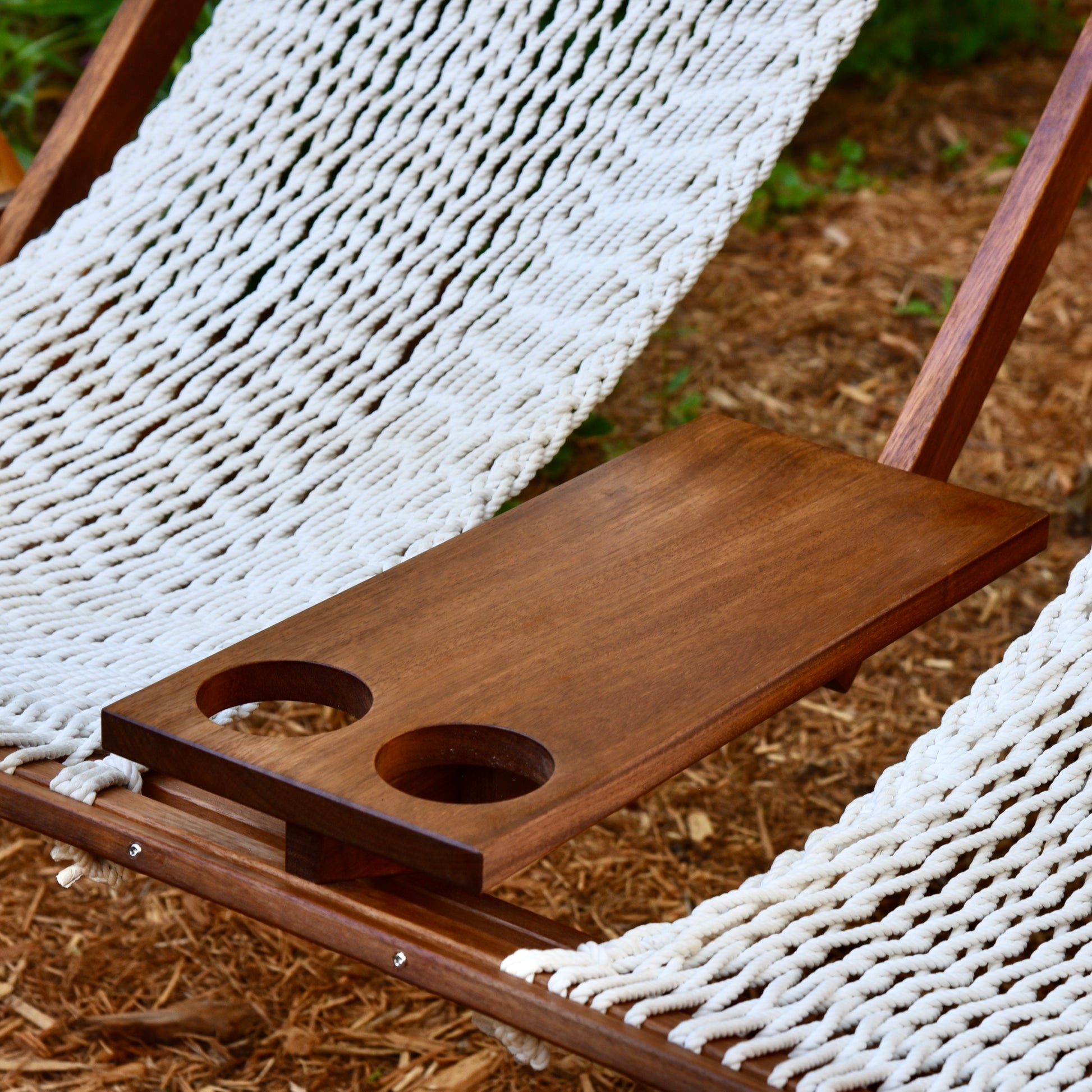 wood table for a swing with two cup holders cut into it