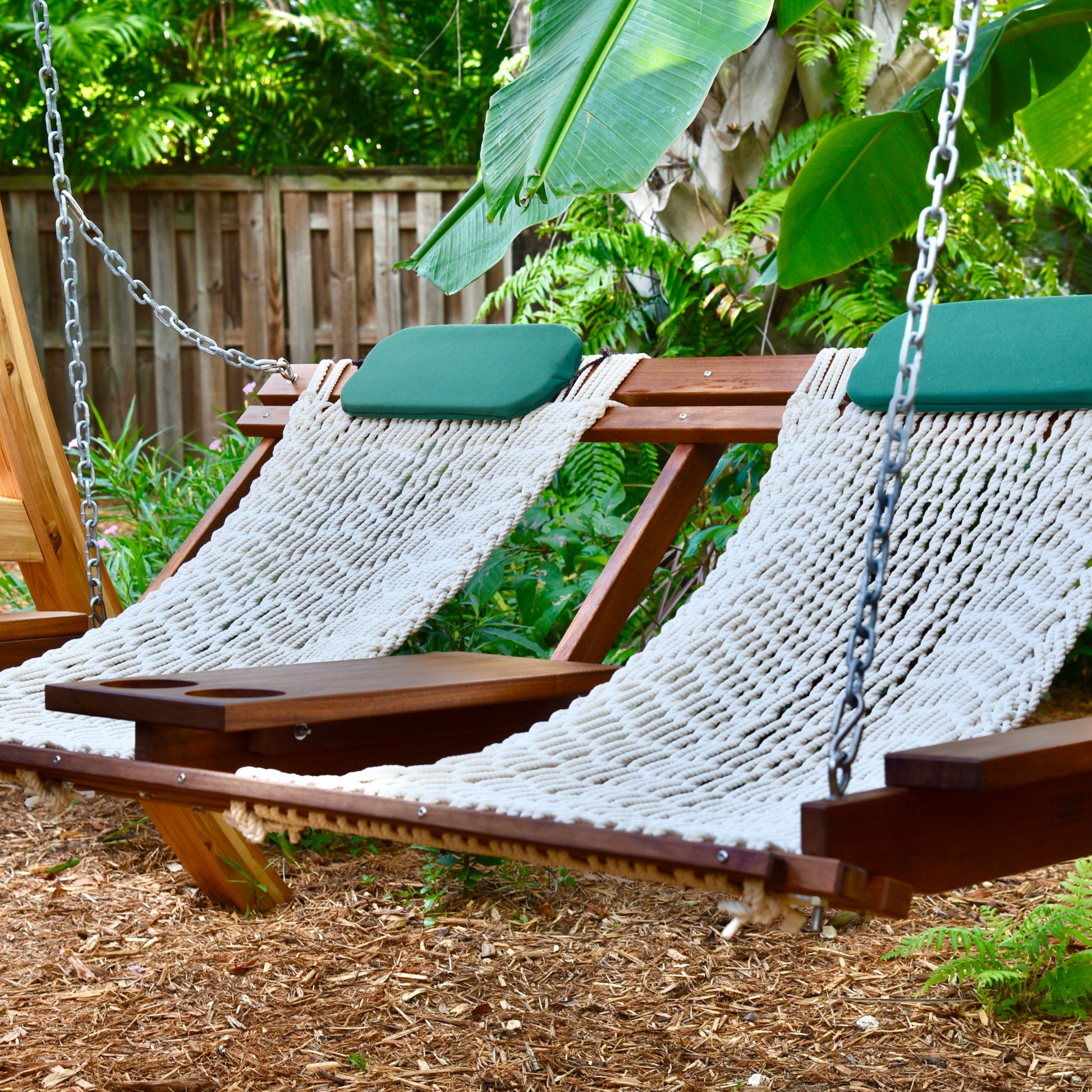 swing with rope seats a table in the middle and cup holders