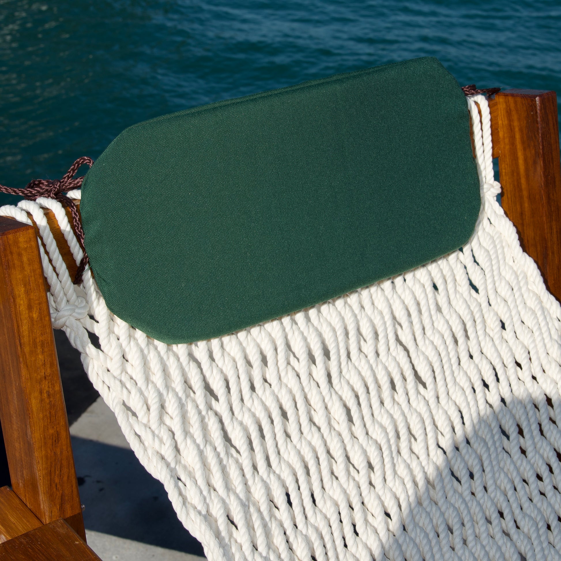 a green furniture pillow on a bar stool