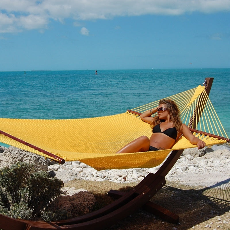 Woman laying in Jumbo Yellow Hammock with Wooden Hammock Stand