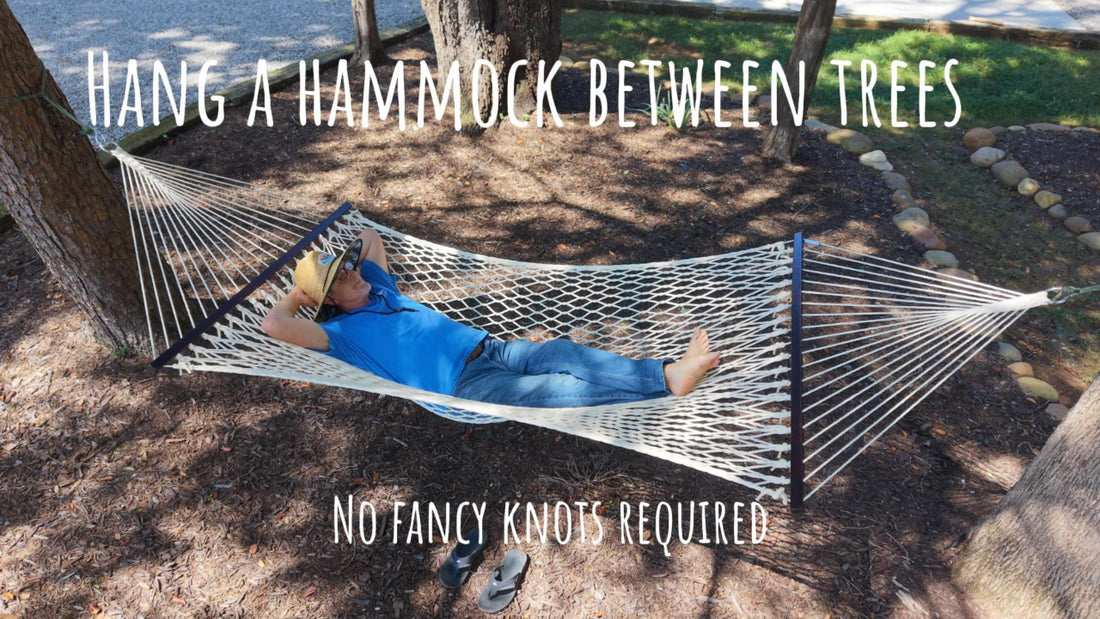 A hammock hung between two trees on braided nylon rope with a three inch S hook at the tree