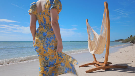 girl walking to a hammock on the beach