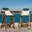 two bar stools overlooking the ocean with rope seats and green pillows