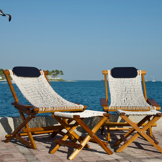 a furniture chair set on a dock overlooking sunset key in key west