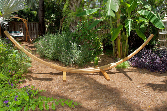 wood hammock stand and swing in a tropical garden