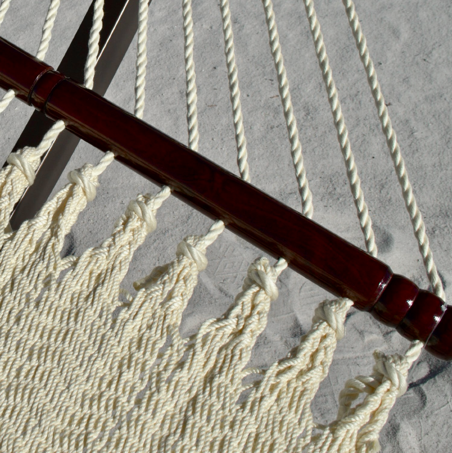 Close-up of the varnished hardwood spreader bar and end cords on the Cream Double Caribbean Hammock