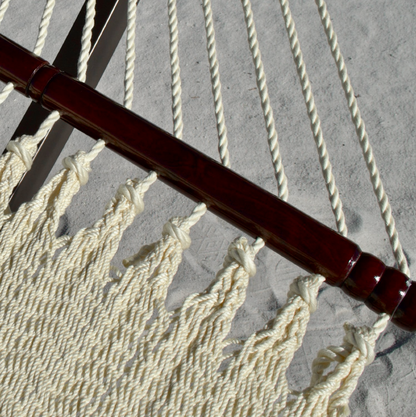 Close-up of the varnished hardwood spreader bar and end cords on the Cream Double Caribbean Hammock