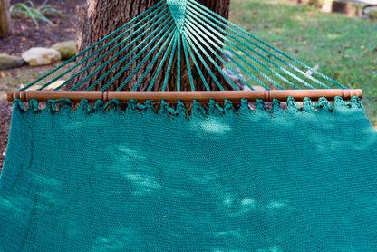 End cords fanning above the hardwood spreader bar of the Green Double Caribbean Hammock