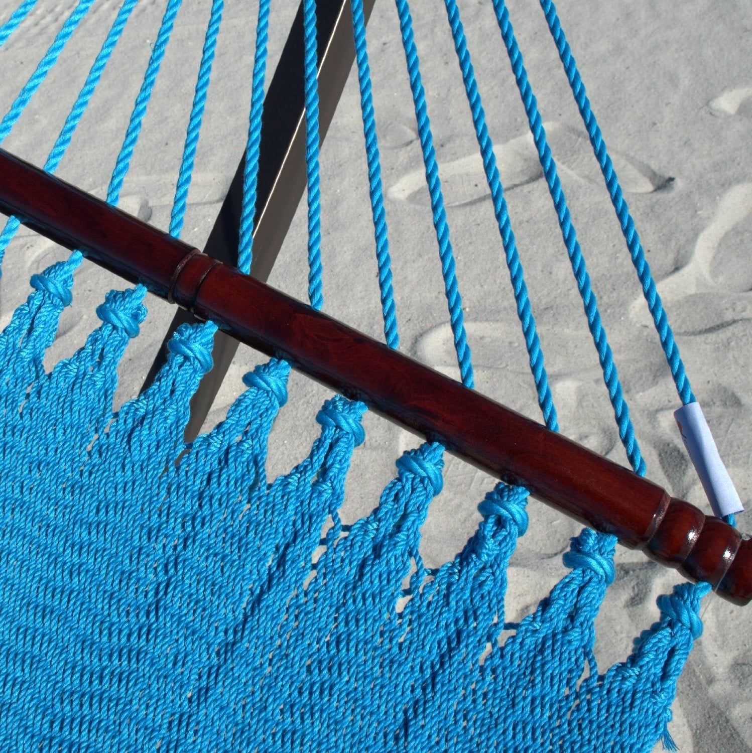 Close-up of the varnished hardwood spreader bar and end cords on the Light Blue Double Caribbean Hammock