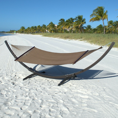 Mocha Double Caribbean Hammock hanging on the Wood Arc Hammock Stand on a palm-lined beach