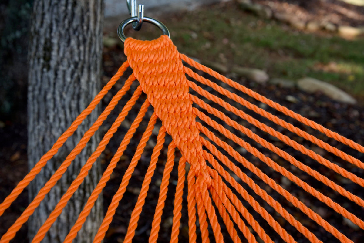 Clew knot on an Orange Double Caribbean Hammock, polyester cords gathered into a stainless steel O-ring