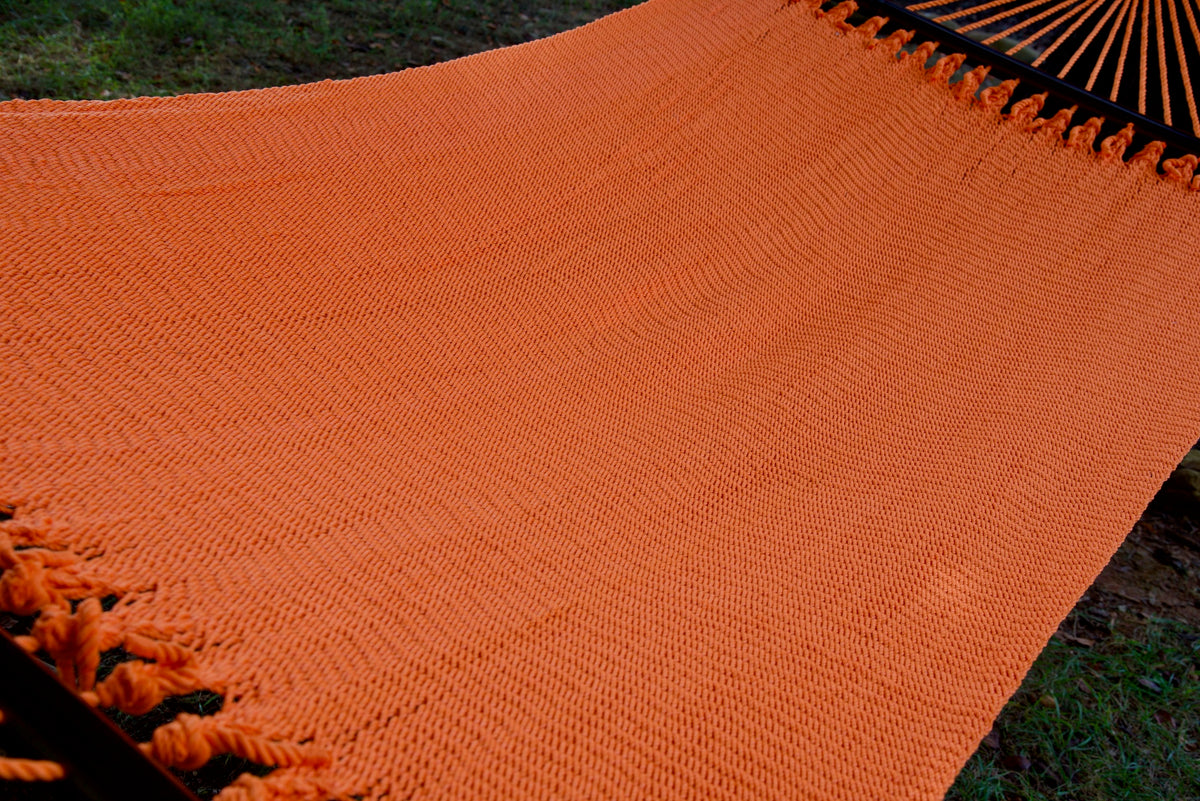 The full hand-woven bed of the Orange Double Caribbean Hammock seen end to end
