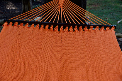 End cords fanning above the hardwood spreader bar of the Orange Double Caribbean Hammock