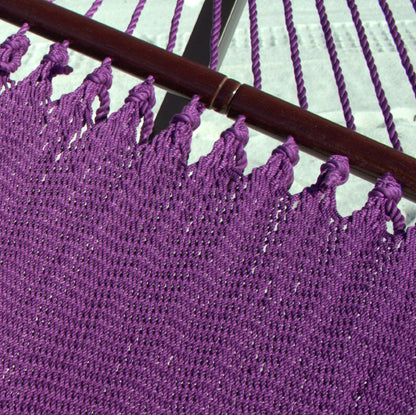 Close-up of the varnished hardwood spreader bar and end cords on the Purple Double Caribbean Hammock