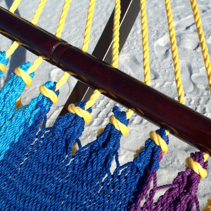Close-up of the varnished hardwood spreader bar and end cords on the Rainbow Double Caribbean Hammock