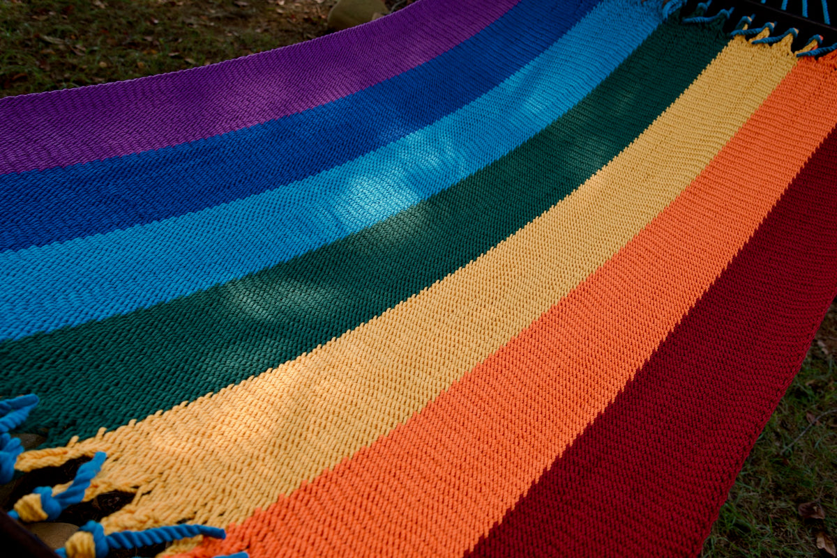 The full striped hand-woven bed of the Rainbow Double Caribbean Hammock seen end to end