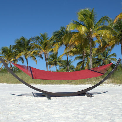 Red Double Caribbean Hammock hanging on the Wood Arc Hammock Stand on a palm-lined beach