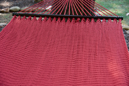 End cords fanning above the hardwood spreader bar of the Red Double Caribbean Hammock