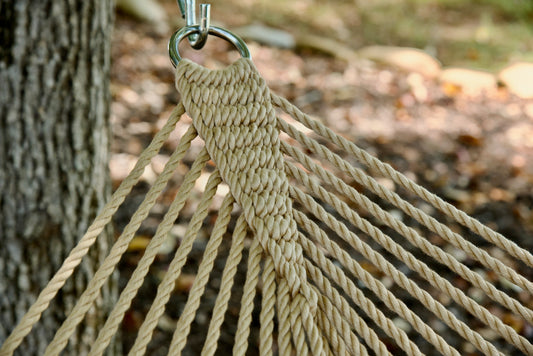 Clew knot on a Tan Double Caribbean Hammock, polyester cords gathered into a stainless steel O-ring