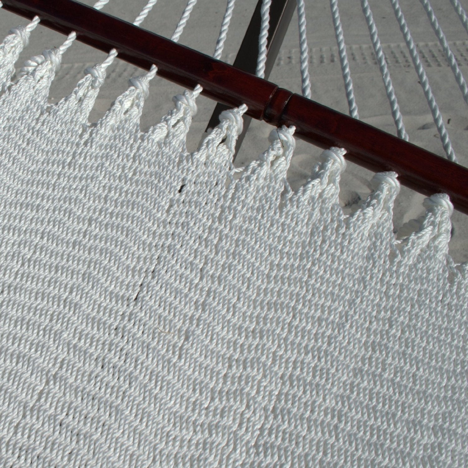 Close-up of the varnished hardwood spreader bar and end cords on the White Double Caribbean Hammock