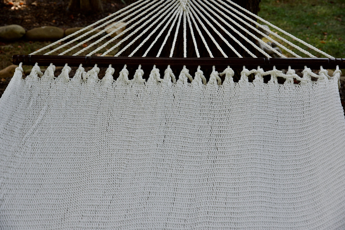 End cords fanning above the hardwood spreader bar of the White Double Caribbean Hammock