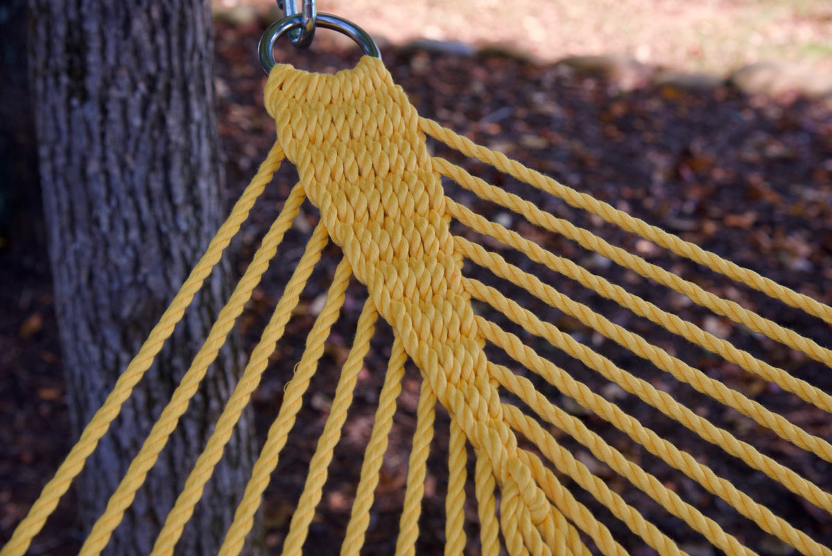 Clew knot on a Yellow Double Caribbean Hammock, polyester cords gathered into a stainless steel O-ring