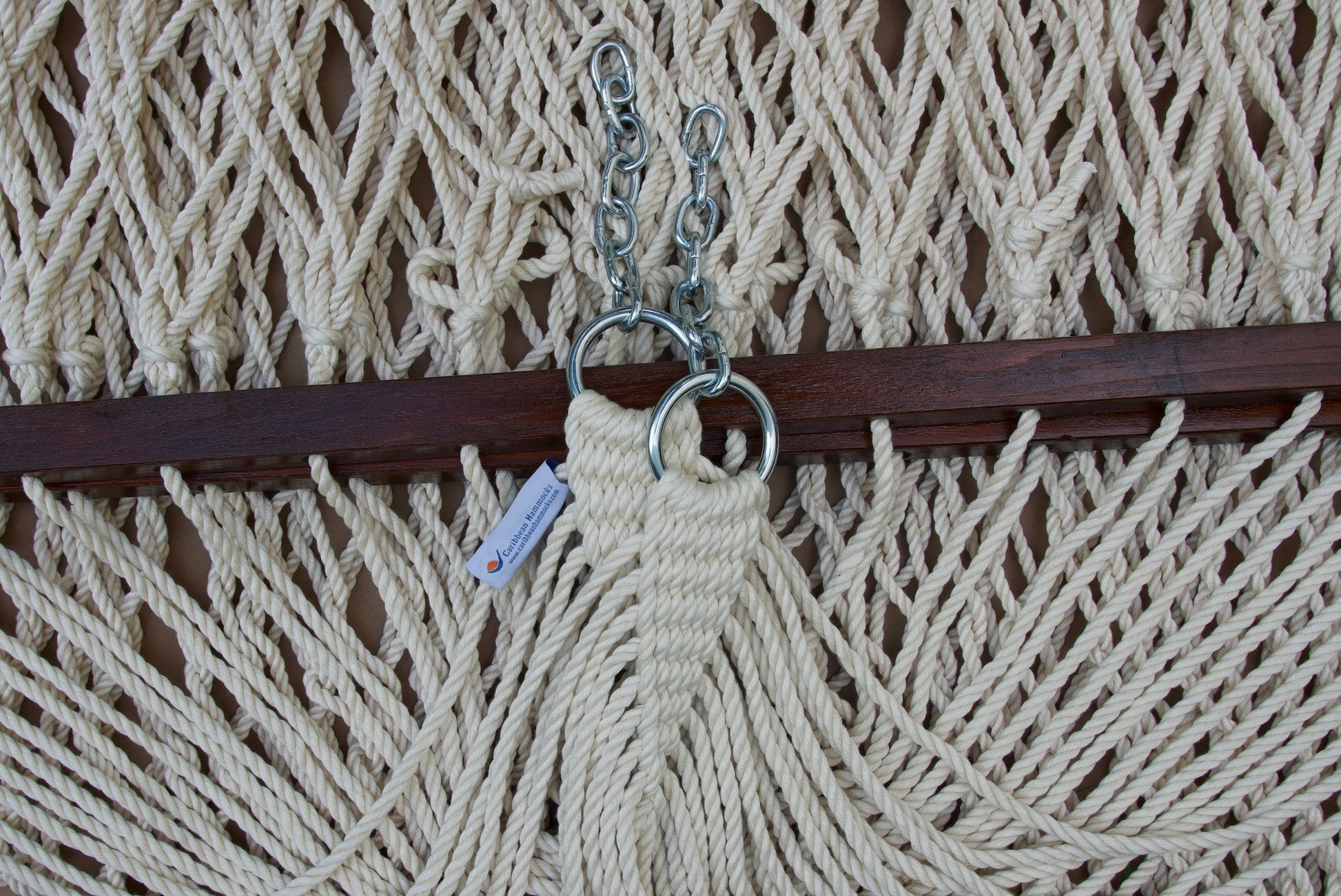 Clew knot on a cream Island Escape hammock, polyester cords gathered into stainless steel rings with hanging chain and Caribbean Hammocks label