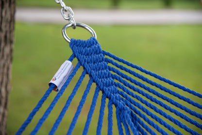 Stainless steel hanging ring, polyester end cords, and clew knot on a dark blue Island Escape hammock, lawn behind