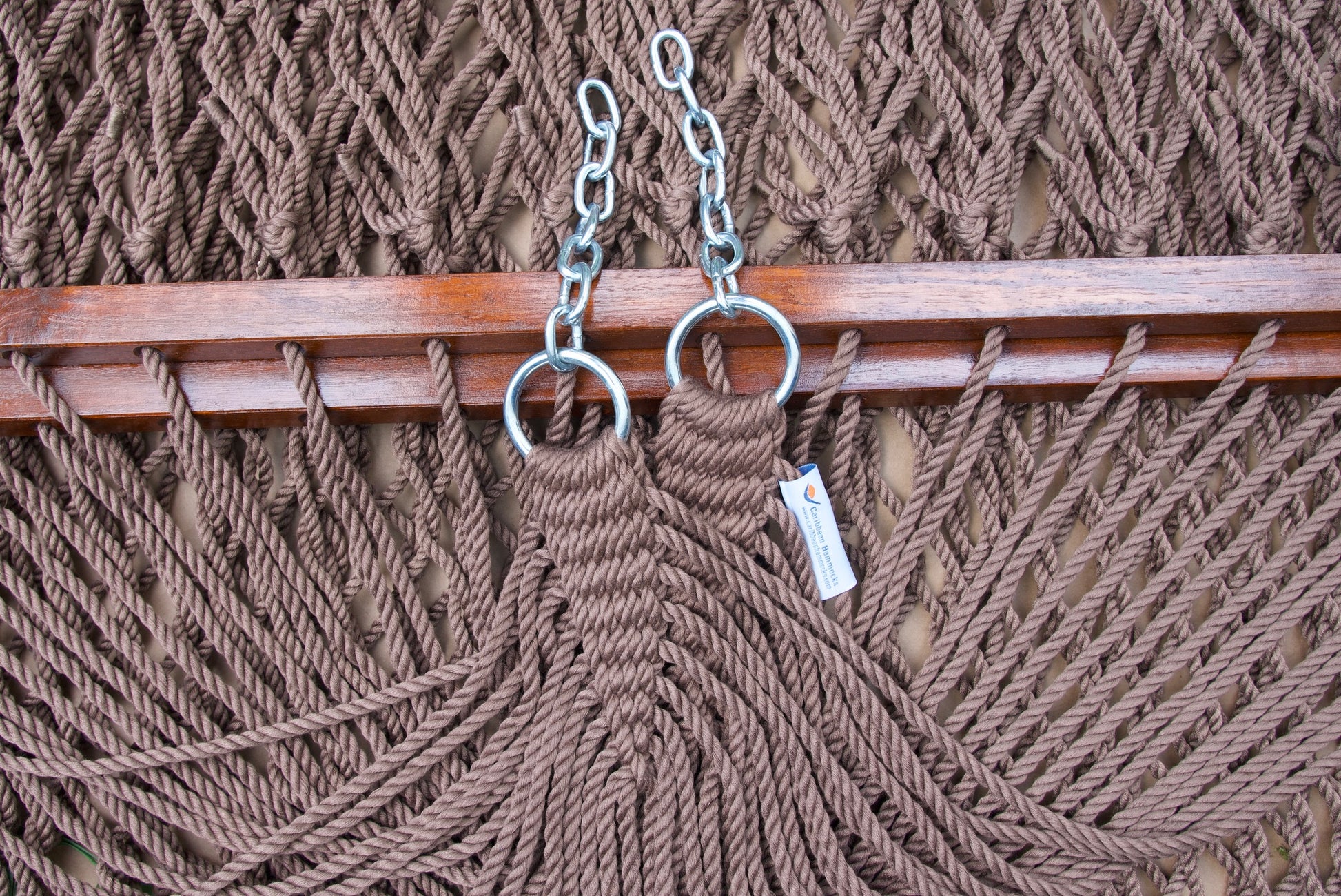 Clew knot on a mocha Island Escape hammock, polyester cords gathered into stainless steel rings with hanging chain and Caribbean Hammocks label