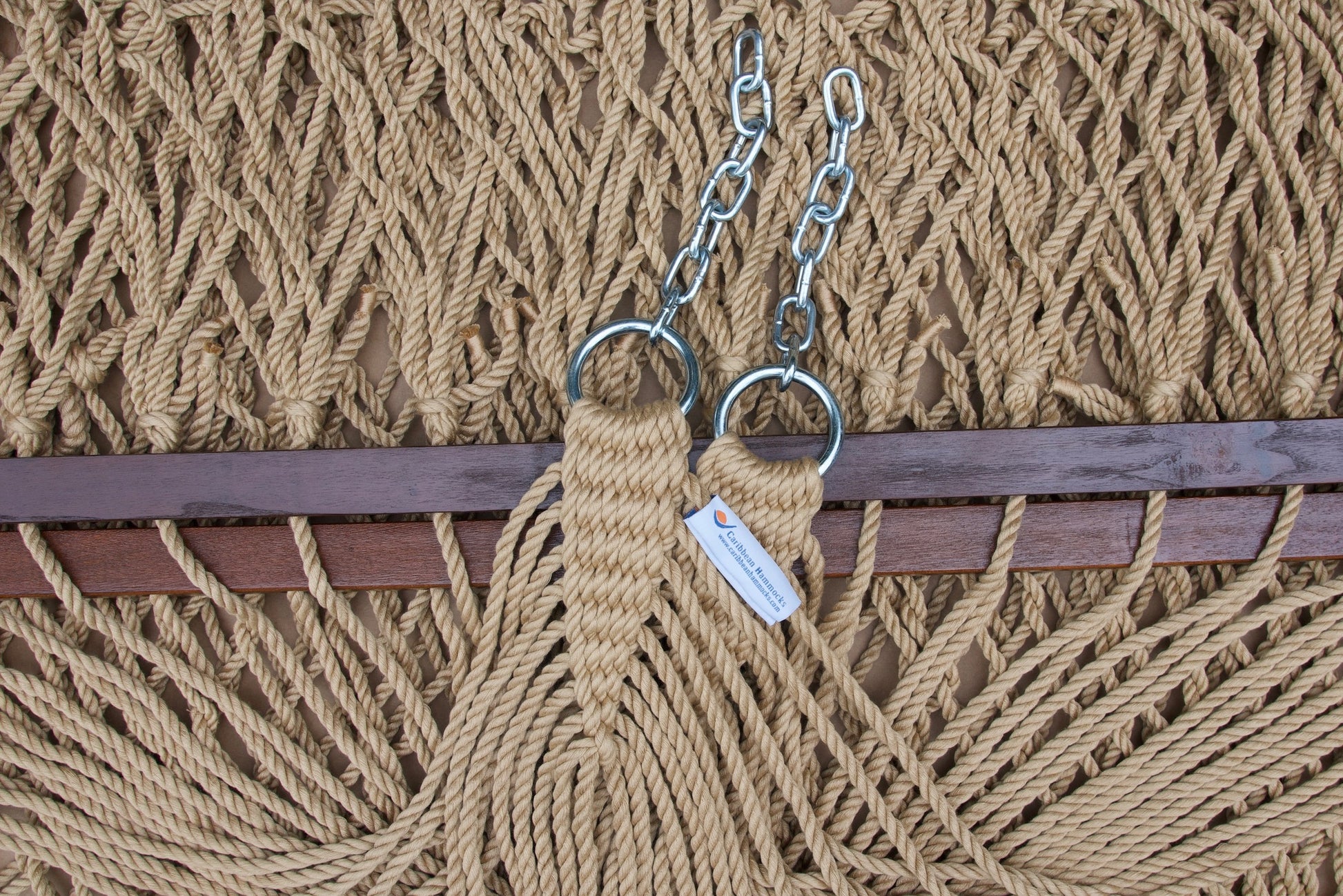 Clew knot on a tan Island Escape hammock, polyester cords gathered into stainless steel rings with hanging chain and Caribbean Hammocks label