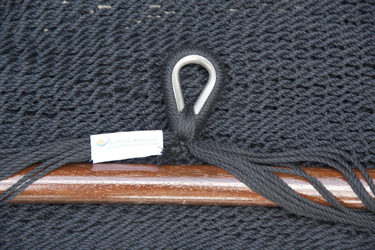 Close-up of the sewn brand label and zinc-plated ring at the seat edge of a black Island Haven hammock chair