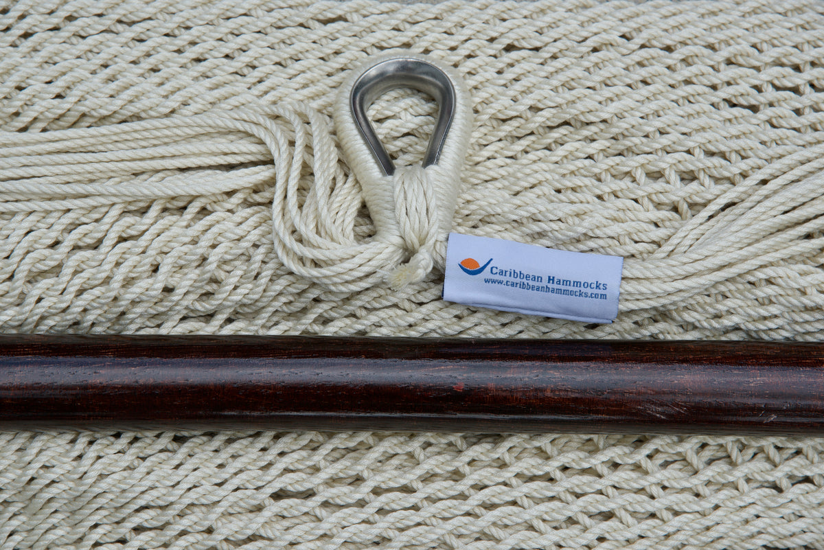 Close-up of the sewn brand label and zinc-plated ring at the seat edge of a cream Island Haven hammock chair