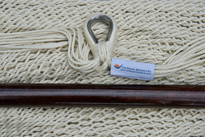 Close-up of the sewn brand label and zinc-plated ring at the seat edge of a cream Island Haven hammock chair