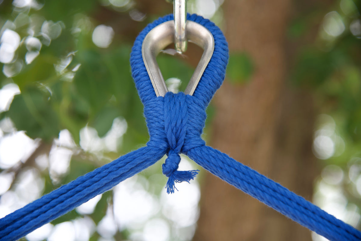 Close-up of the zinc-plated hanging ring where the dark blue end cords of an Island Haven hammock chair meet