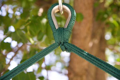 Close-up of the zinc-plated hanging ring where the green end cords of an Island Haven hammock chair meet