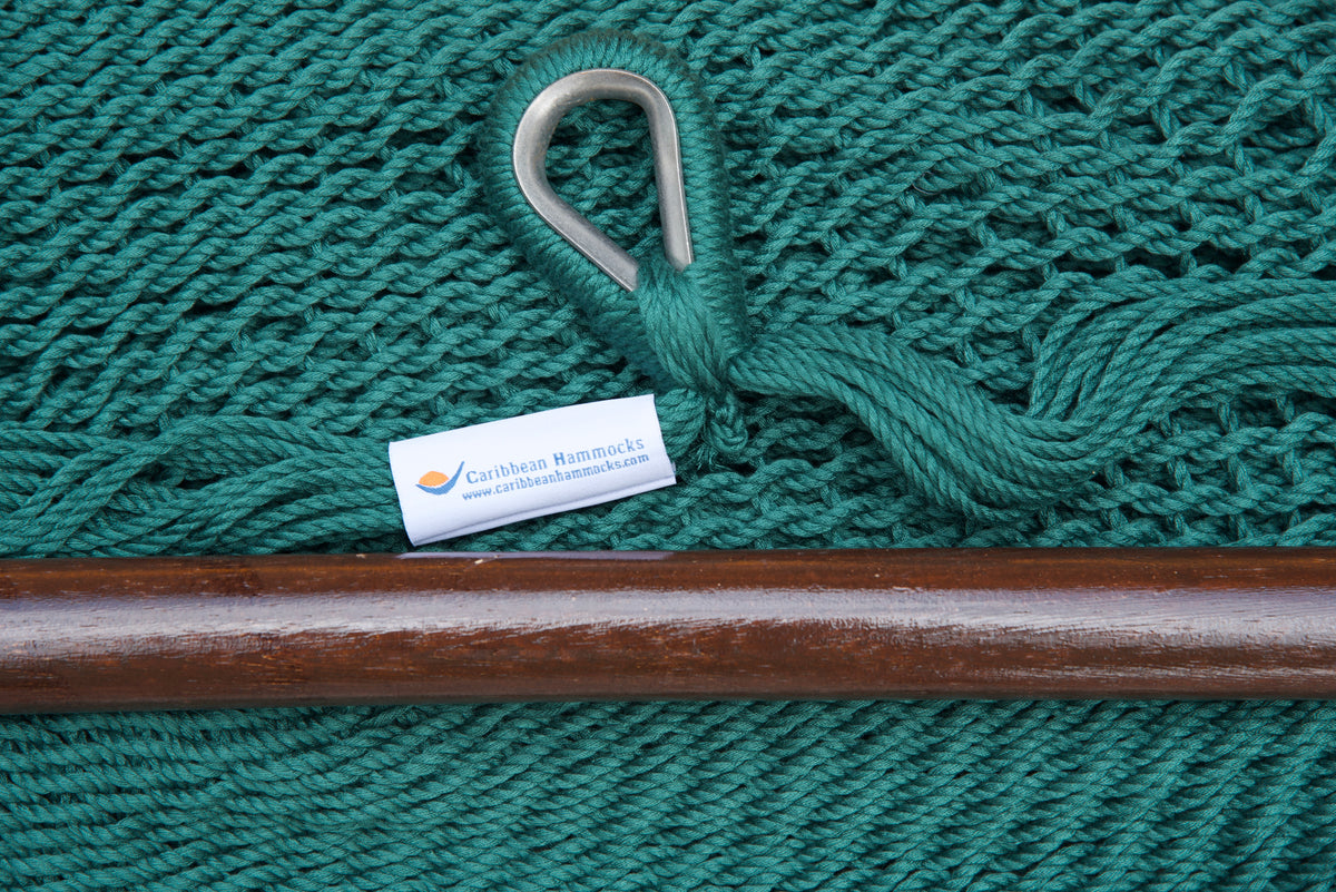 Close-up of the sewn brand label and zinc-plated ring at the seat edge of a green Island Haven hammock chair