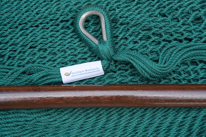 Close-up of the sewn brand label and zinc-plated ring at the seat edge of a green Island Haven hammock chair