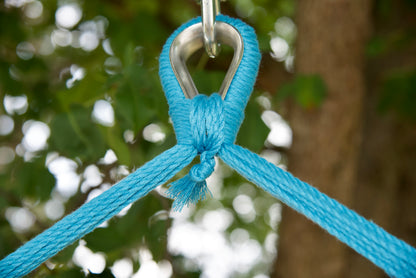 Close-up of the zinc-plated hanging ring where the light blue end cords of an Island Haven hammock chair meet