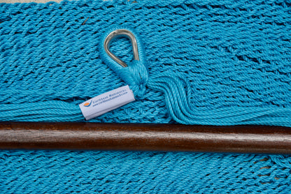 Close-up of the sewn brand label and zinc-plated ring at the seat edge of a light blue Island Haven hammock chair