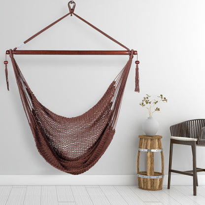 Mocha Island Haven hammock chair hanging beside a barrel side table and bar stool against a pale grey wall