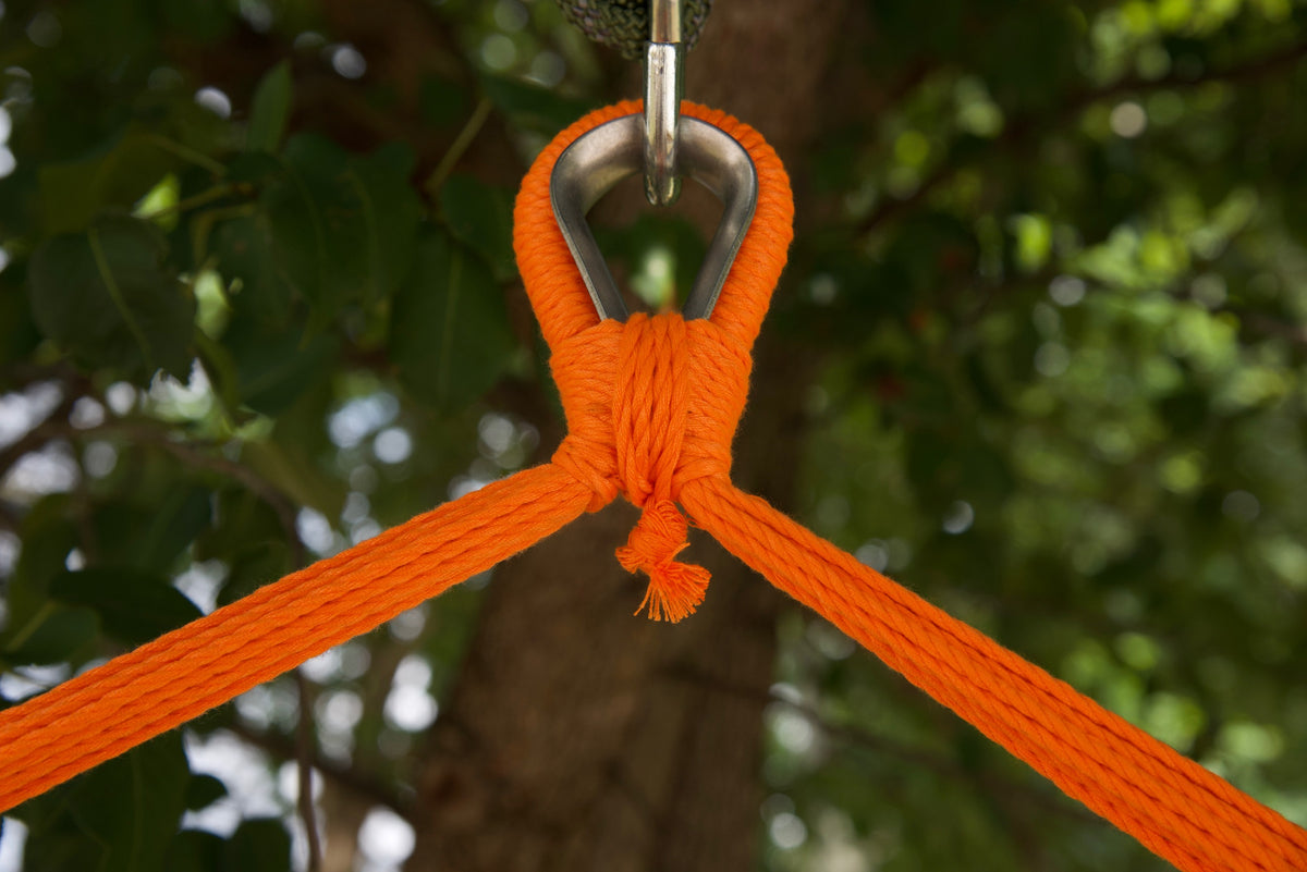 Close-up of the zinc-plated hanging ring where the orange end cords of an Island Haven hammock chair meet