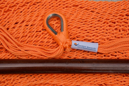 Close-up of the sewn brand label and zinc-plated ring at the seat edge of an orange Island Haven hammock chair