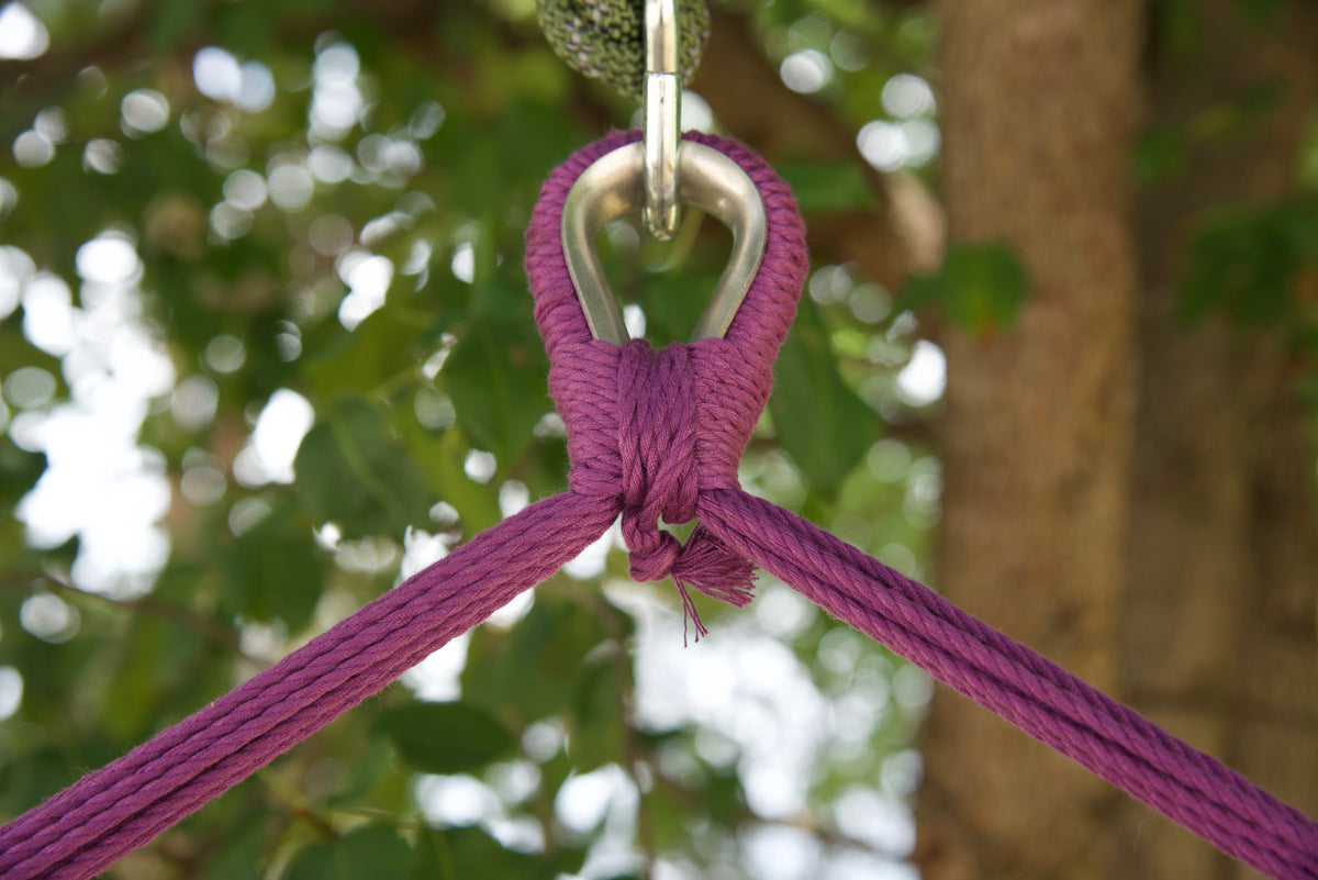 Close-up of the zinc-plated hanging ring where the purple end cords of an Island Haven hammock chair meet