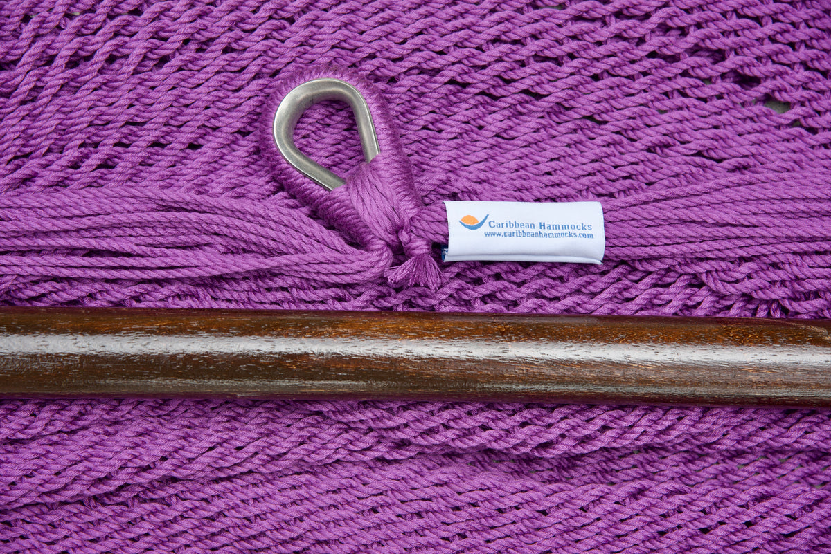 Close-up of the sewn brand label and zinc-plated ring at the seat edge of a purple Island Haven hammock chair