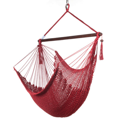 Island Haven hammock chair in red, hand-woven poly cord with a dark hardwood spreader bar and tasseled ends, on a white background