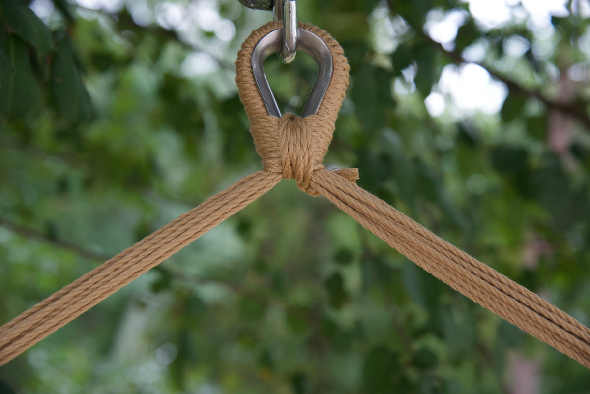 Close-up of the zinc-plated hanging ring where the tan end cords of an Island Haven hammock chair meet